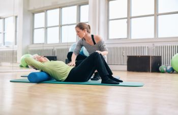 mat exercises performed by woman patient under supervision of a woman specialist atlanta, ga