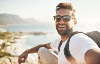 Cropped portrait of a handsome young man taking selfies while hiking in the mountains.