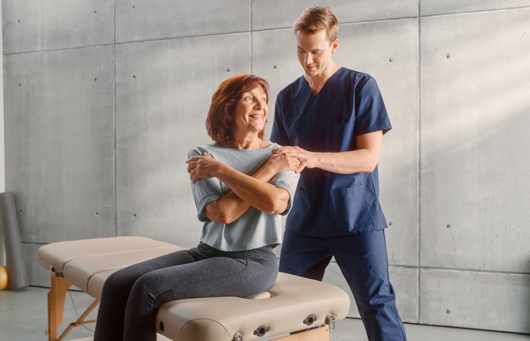 Professional Sport Physiotherapist Treating on Specific Muscle Groups and Back Pain with Middle Aged Fit Female. Senior Woman Recovering from Mild Injury. Trauma Prevention Therapy, Rehabilitation.