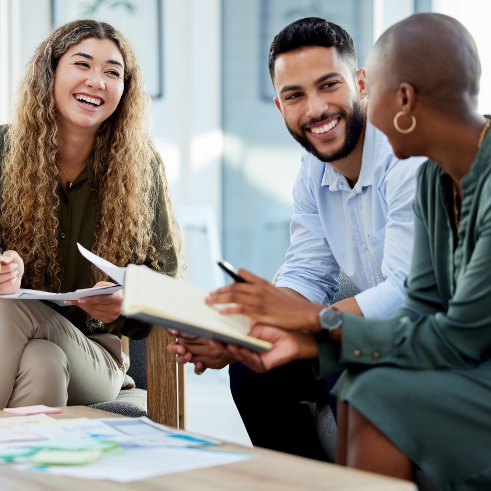 Happy business people smile during a planning meeting in a startup marketing agency office. Diversity, collaboration and teamwork in a healthy work environment in an international advertising company.