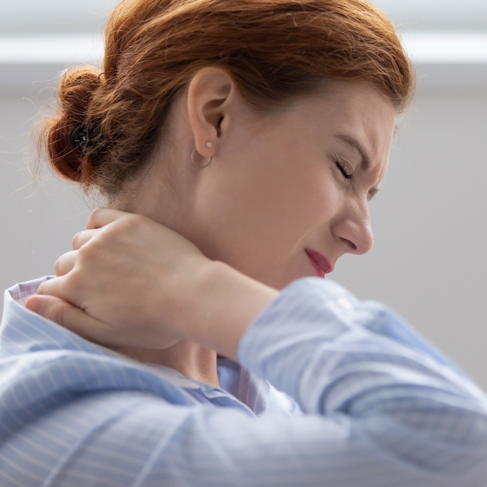 Tired fatigued business woman office worker feeling pain chronic discomfort injury hurt rubbing stiff tensed sore neck muscles suffer from fibromyalgia ache after sedentary work in incorrect posture