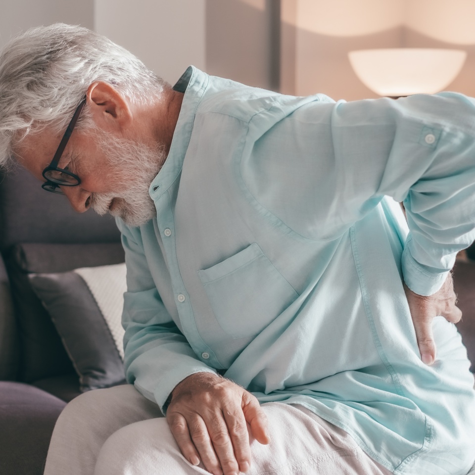 Senior elder man feel sudden back pain muscles ache tension injury at home, sad old grandfather touching spine having lower lumbago backache osteoarthritis arthritis, backache concept