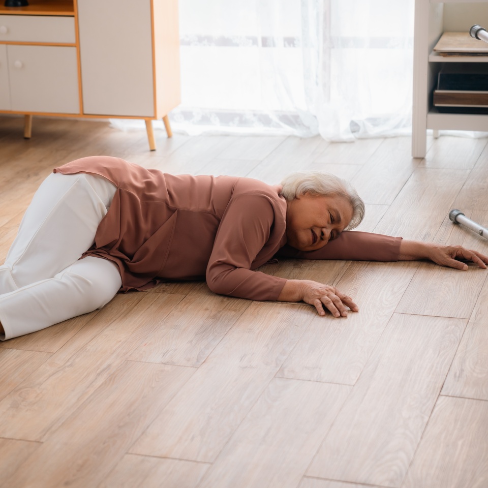 caregiver support senior elderly patient who having accident to fall on the floor at home, health insurance for emergency help, woman nurse having care injury to disease pain of old Asian people