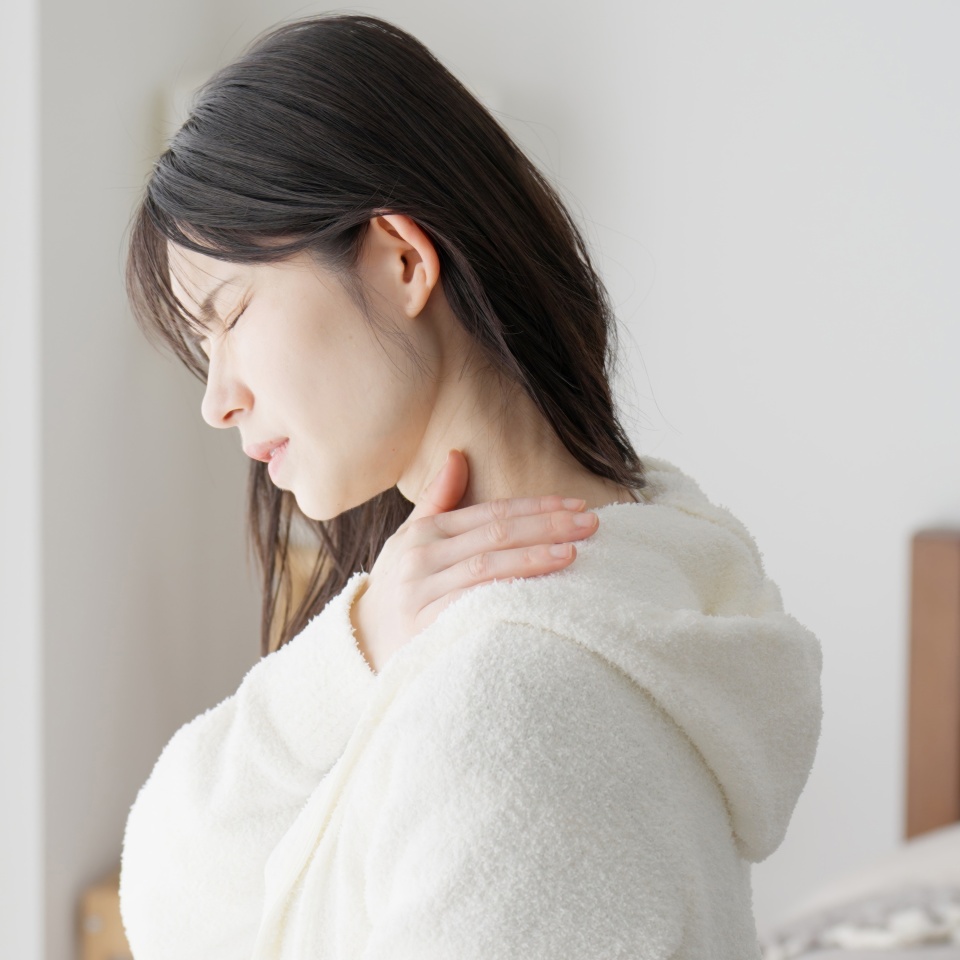 A woman caring about her aching shoulder