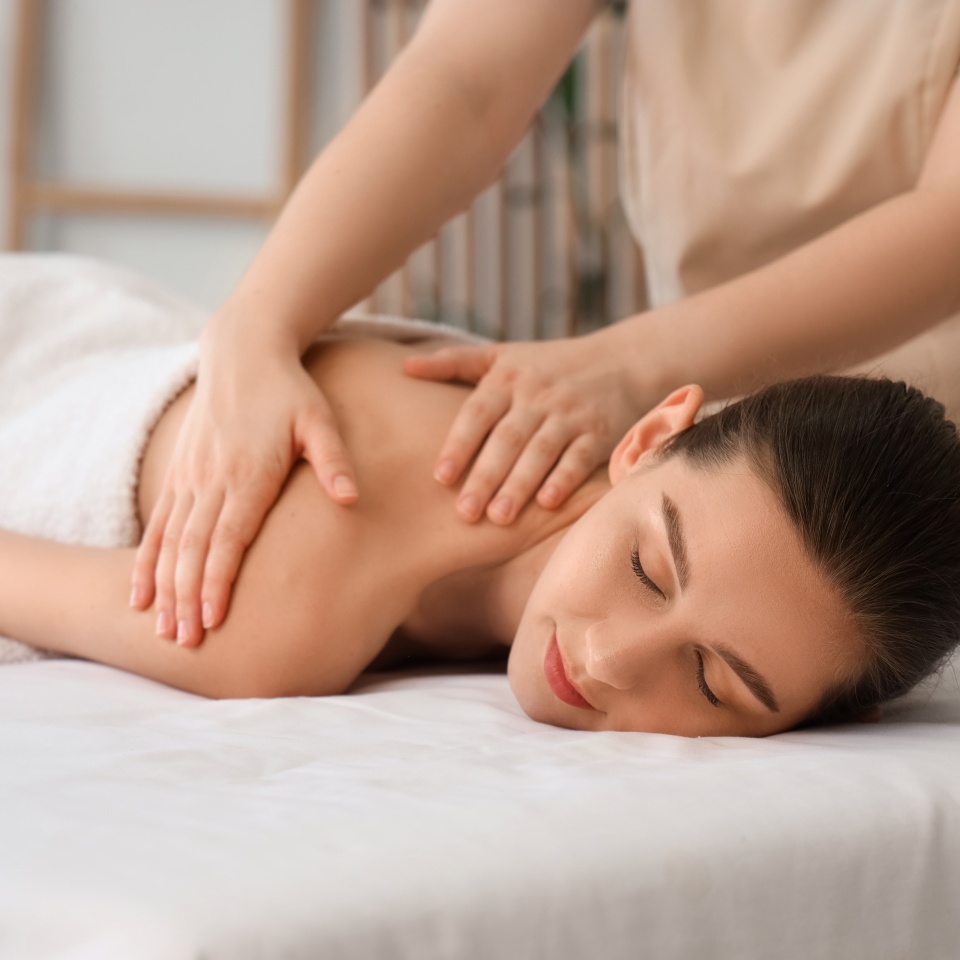 Young woman getting massage on couch in spa salon, closeup