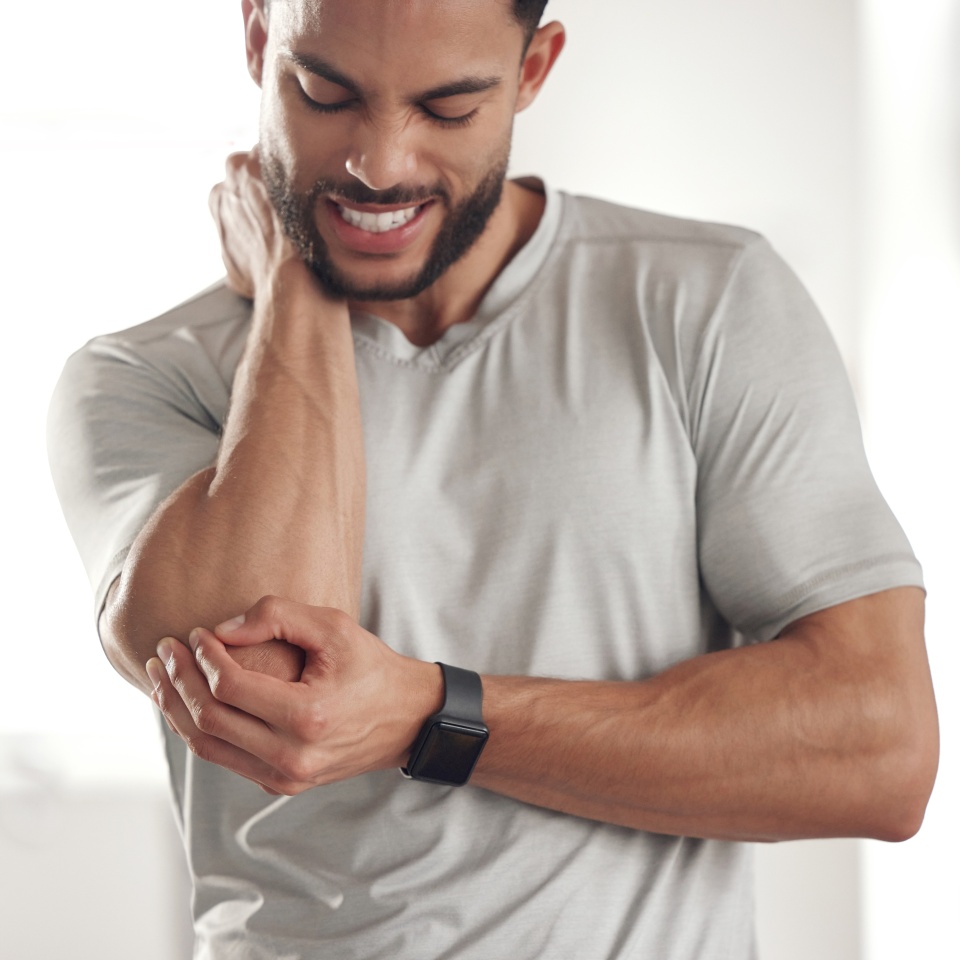 Fitness, stress and man with elbow pain for in gym for training, discomfort and joint problem. Frustrated, athlete and person with workout emergency for bursitis, inflammation and injury in exercise