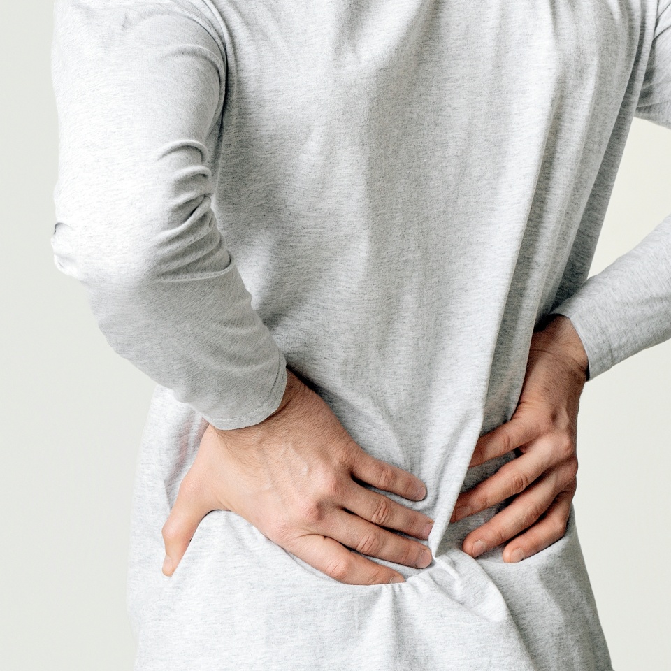Kidney pain concept. Man presses hands to his back, panorama