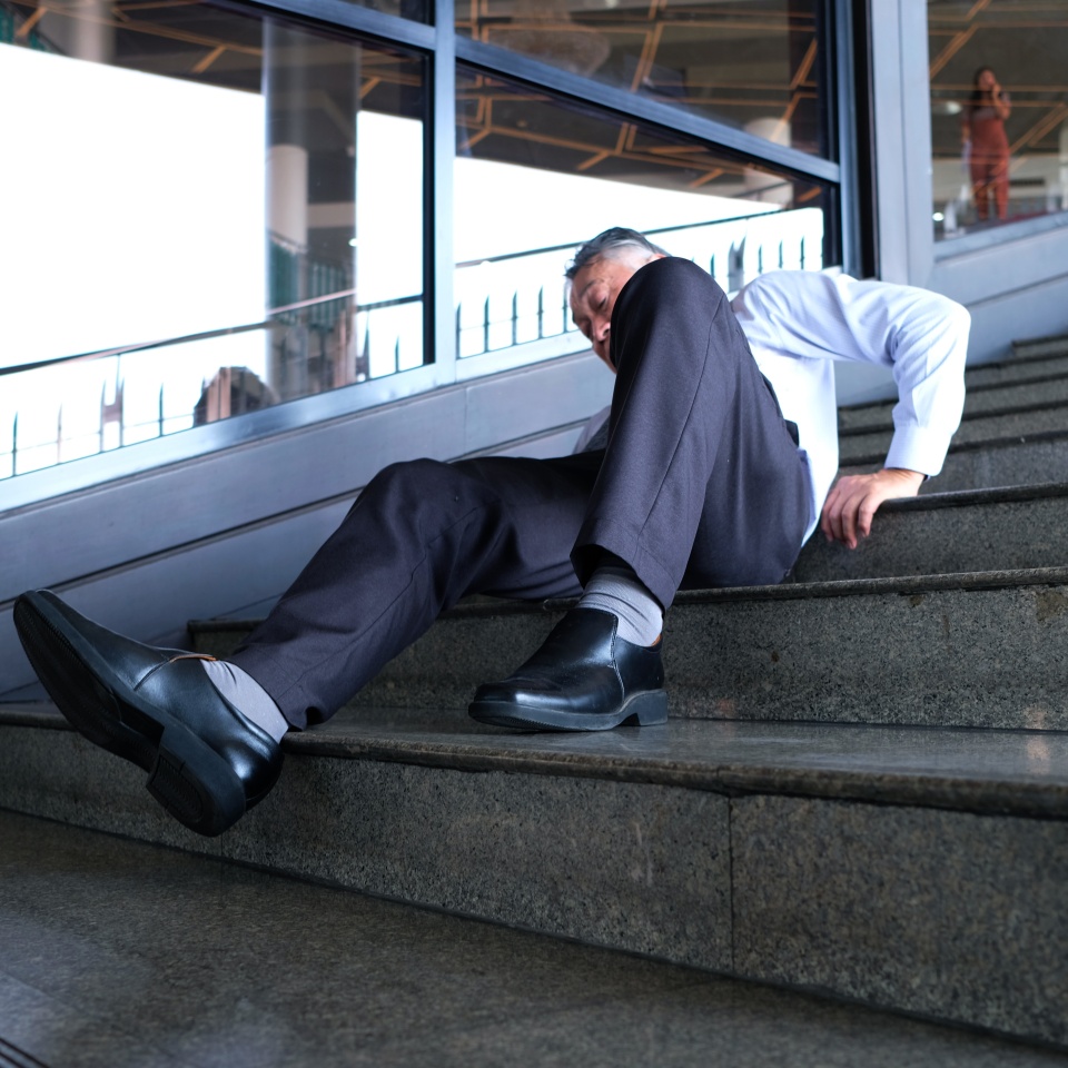 A man falls down the stairs and is injured.
