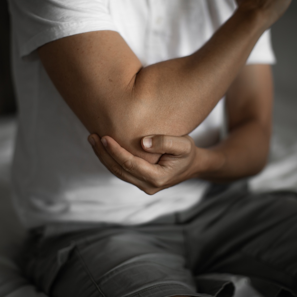 Man with elbow injury, pain relief concept concept muscle pain due to lateral epicondylitis or tennis elbow injury, Health care concept