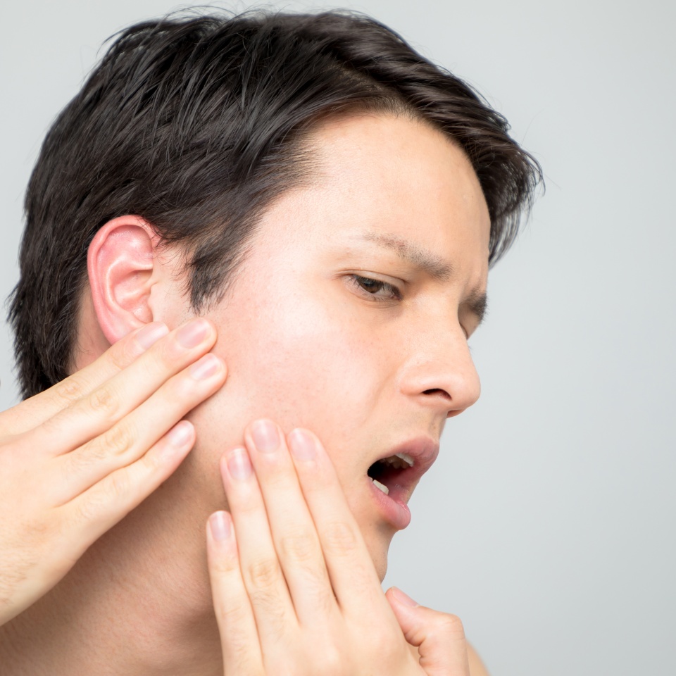 Young man checking his skin, men's skincare concept, acne treatment