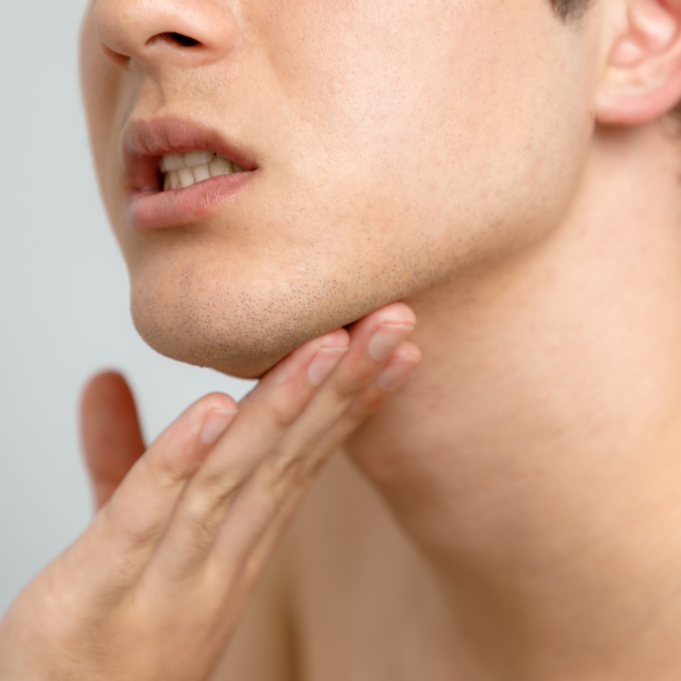 Young man checking his skin, men's skincare concept, acne treatment
